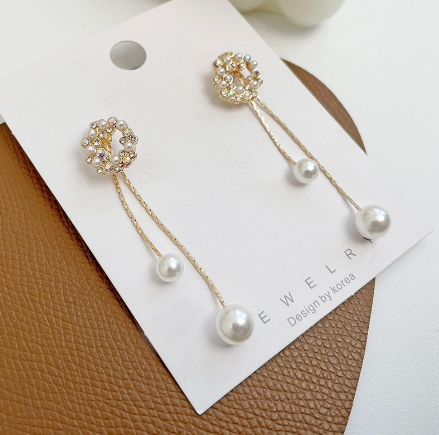 Orecchini con perle dorate e dettagli strass a festone